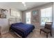 Bright bedroom with a metal bed frame, carpeting, neutral walls and trim, and a decoratively framed window at 1013 Chelsea Run Ln, Apex, NC 27502