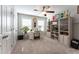 Neutral bedroom featuring a ceiling fan, desk, and ample storage space for a calm, organized ambiance at 1013 Chelsea Run Ln, Apex, NC 27502
