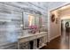 A decorative entryway with a mirror, console table and wood accent wall at 1013 Chelsea Run Ln, Apex, NC 27502