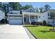 Charming home with a well-manicured lawn, front porch, and two-car garage at 1013 Chelsea Run Ln, Apex, NC 27502