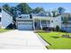 Charming home with a well-manicured lawn, front porch, and two-car garage at 1013 Chelsea Run Ln, Apex, NC 27502
