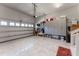 Spacious garage featuring a clean epoxy floor, ample cabinet storage, and a well-organized tool area at 1013 Chelsea Run Ln, Apex, NC 27502
