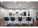 Beautiful kitchen with a large island, white cabinets, stainless steel appliances and decorative bar stools at 1013 Chelsea Run Ln, Apex, NC 27502