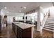Open concept kitchen with granite countertops and stainless steel appliances, great for entertaining at 1013 Chelsea Run Ln, Apex, NC 27502