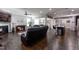 Open-concept living area featuring fireplace, wood floors, and seamless flow to the kitchen at 1013 Chelsea Run Ln, Apex, NC 27502