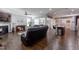 Open-concept living area featuring fireplace, wood floors, and seamless flow to the kitchen at 1013 Chelsea Run Ln, Apex, NC 27502