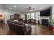 Spacious living room with hardwood floors, stone fireplace, and comfortable seating area at 1013 Chelsea Run Ln, Apex, NC 27502