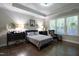 Comfortable main bedroom featuring hardwood floors, tray ceiling, and natural lighting at 1013 Chelsea Run Ln, Apex, NC 27502