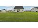 Expansive backyard with green grass, a patio, and a fire pit at 105 Chandon Dr, Princeton, NC 27569