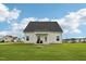 Spacious backyard featuring green grass, a fire pit, and a covered patio at 105 Chandon Dr, Princeton, NC 27569