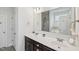 Bright bathroom featuring double sinks, a large mirror, vanity lighting and modern fixtures at 105 Chandon Dr, Princeton, NC 27569