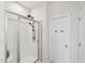 Modern bathroom featuring a glass enclosed shower with dual shower heads and a white painted door at 105 Chandon Dr, Princeton, NC 27569