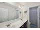 Bathroom featuring double sinks, large mirror, vanity lighting, dark cabinets and tile flooring at 105 Chandon Dr, Princeton, NC 27569