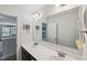Bathroom featuring double sinks, a large mirror, vanity lighting and dark wood cabinets at 105 Chandon Dr, Princeton, NC 27569