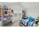 Bright bedroom featuring a study area and large windows with natural light and blue color accents at 105 Chandon Dr, Princeton, NC 27569