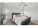 Bright bedroom with a tray ceiling, ceiling fan, a large bed and a telescope near a window at 105 Chandon Dr, Princeton, NC 27569