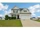Charming two-story home with a well-manicured lawn and attached two-car garage at 105 Chandon Dr, Princeton, NC 27569