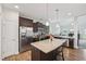 Modern kitchen featuring stainless steel appliances, granite countertops, and a spacious island at 105 Chandon Dr, Princeton, NC 27569