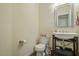 Powder room featuring a pedestal sink, toilet, and neutral decor at 11 Grifton Pl, Durham, NC 27704