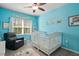Charming Bedroom with a white crib, comfortable chair, and a delightful Winnie the Pooh theme at 11 Grifton Pl, Durham, NC 27704