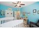 Bright Bedroom features a white crib, Winnie the Pooh decor, and convenient storage shelves at 11 Grifton Pl, Durham, NC 27704
