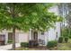 Beautiful townhouse with well-kept landscaping, a front porch sitting area, and an attached garage at 11 Grifton Pl, Durham, NC 27704