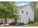 Well-maintained townhouse featuring an attached garage, landscaping, and a front porch seating area at 11 Grifton Pl, Durham, NC 27704