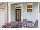Cozy front porch with chairs adjacent to front door at 11 Grifton Pl, Durham, NC 27704