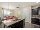 Open kitchen with granite island, stainless appliances, and adjacent dining area at 11 Grifton Pl, Durham, NC 27704