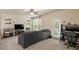 Comfortable living room with a large sofa, ceiling fan, and natural light at 11 Grifton Pl, Durham, NC 27704
