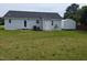 A backyard with grass and a shed, with the back of the house visible at 111 Shadow Bend Ln, Selma, NC 27576