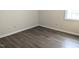 Bedroom with wood-look flooring, neutral paint, and natural light from the window at 111 Shadow Bend Ln, Selma, NC 27576