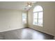 Bright bedroom featuring a ceiling fan, arched window, and modern wood-look flooring at 111 Shadow Bend Ln, Selma, NC 27576