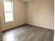 Bedroom featuring hard surface flooring, neutral paint, and a window at 111 Shadow Bend Ln, Selma, NC 27576