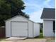 A one-car garage next to the house on a lot with grass at 111 Shadow Bend Ln, Selma, NC 27576