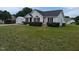 Charming single-story home with a well-manicured lawn, black shutters, and a detached garage at 111 Shadow Bend Ln, Selma, NC 27576
