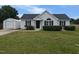 Charming single-story home with a well-manicured lawn, black shutters, and a detached garage at 111 Shadow Bend Ln, Selma, NC 27576