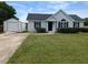 Charming single-story home with a well-manicured lawn, black shutters, and a detached garage at 111 Shadow Bend Ln, Selma, NC 27576