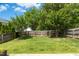 Large, well-maintained backyard with a beautiful grass, mature trees and wooden fence at 1121 Silky Dogwood Trl, Apex, NC 27502