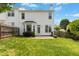 The backyard has a wood fence, green grass, a door, bay window, and patio at 1121 Silky Dogwood Trl, Apex, NC 27502