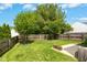 This large backyard features a wood fence, green grass, and a concrete patio at 1121 Silky Dogwood Trl, Apex, NC 27502