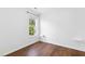 Simple bedroom with natural light, hardwood floors, and white trim, creates a bright and airy space at 1121 Silky Dogwood Trl, Apex, NC 27502