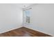 Minimalist bedroom with a large window, hardwood floors, and neutral colors, offering a calm retreat at 1121 Silky Dogwood Trl, Apex, NC 27502