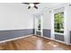Bright bedroom with hardwood floors, two large windows, and fresh neutral paint, ready for personal touches at 1121 Silky Dogwood Trl, Apex, NC 27502