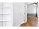 Hallway with hardwood floors, neutral walls, and white doors at 1121 Silky Dogwood Trl, Apex, NC 27502