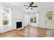 Bright living room features hardwood floors, white walls, and fireplace at 1121 Silky Dogwood Trl, Apex, NC 27502