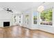 Bright living room features hardwood floors, white walls, and many windows at 1121 Silky Dogwood Trl, Apex, NC 27502