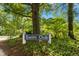 Community Swim Club sign nestled in a lush, green environment surrounded by mature trees at 1121 Silky Dogwood Trl, Apex, NC 27502