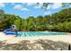 Community swimming pool with a slide, lounge chairs, and plenty of space for recreation at 1121 Silky Dogwood Trl, Apex, NC 27502