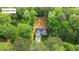 Aerial view of home nestled in the woods, showcasing its unique location with mature trees at 118 Chanute Cir, Louisburg, NC 27549